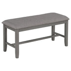 Ensemble de salle à manger traditionnel gris en bois, composé d'une table, de quatre chaises rembourrées et d'un banc.